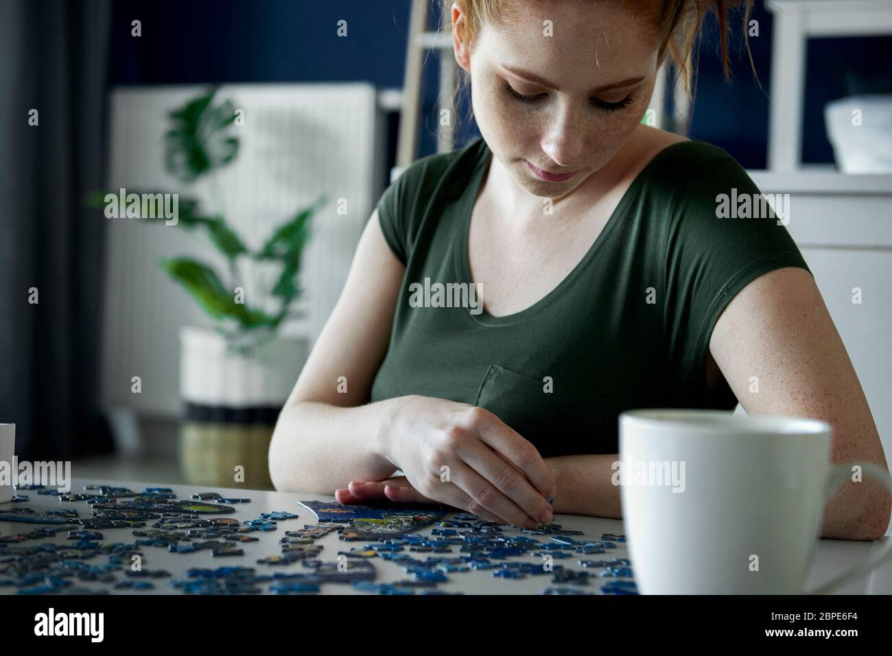 Bored woman over a puzzle game Stock Photo