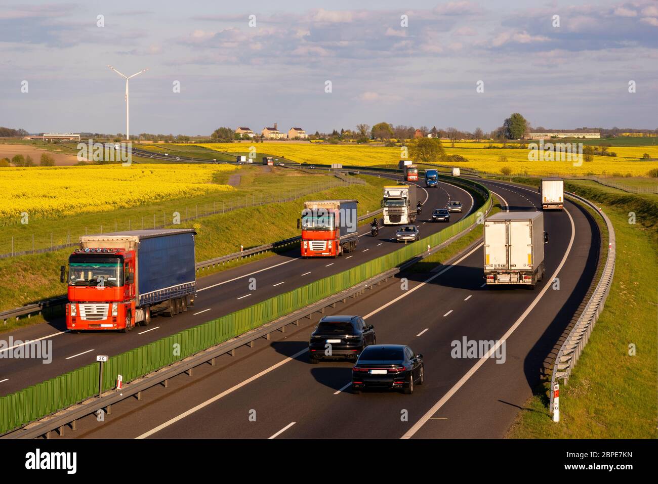 heavy truck traffic on the highway in the evening Stock Photo - Alamy