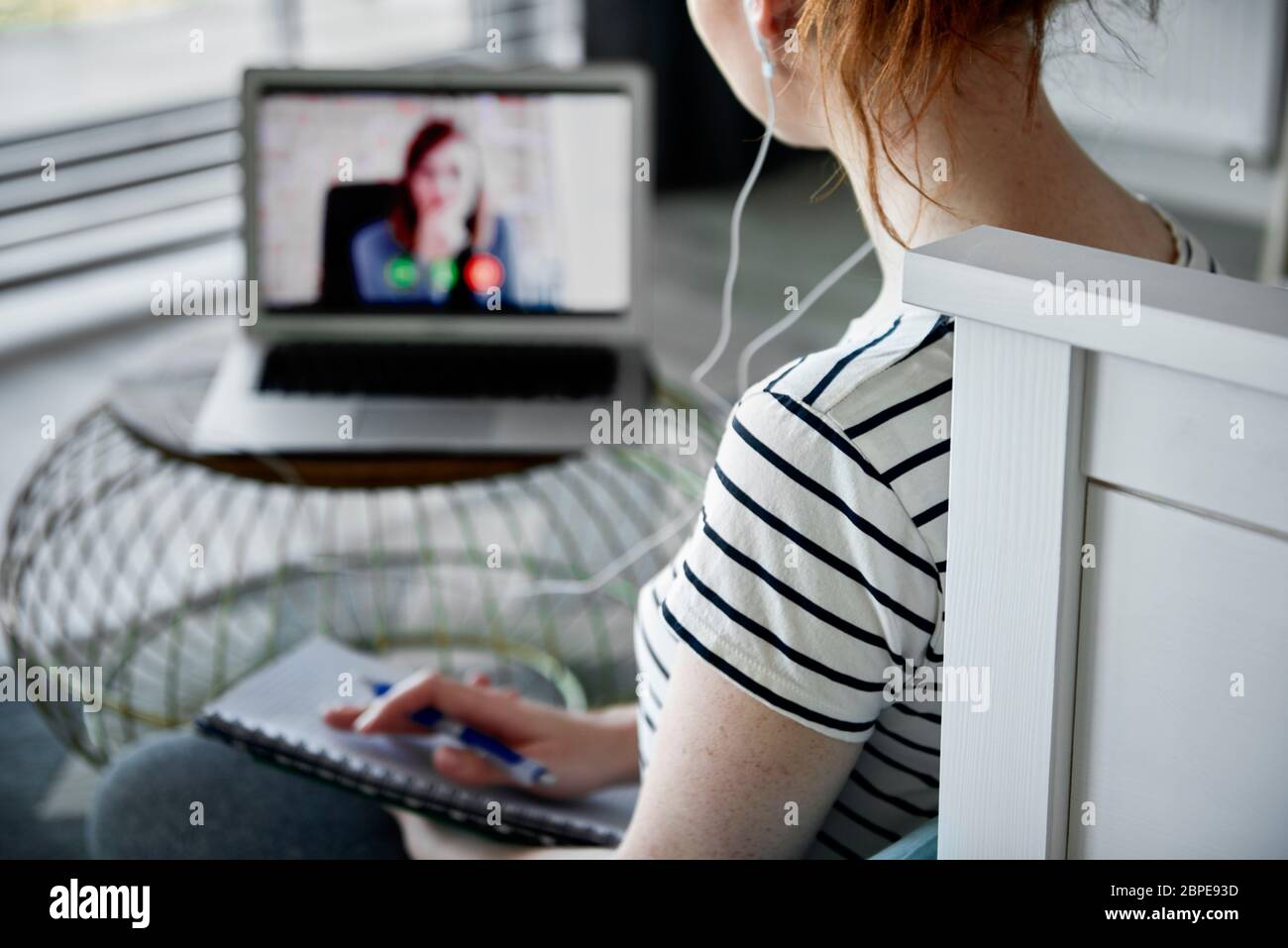 Rear view of woman having a video conference Stock Photo