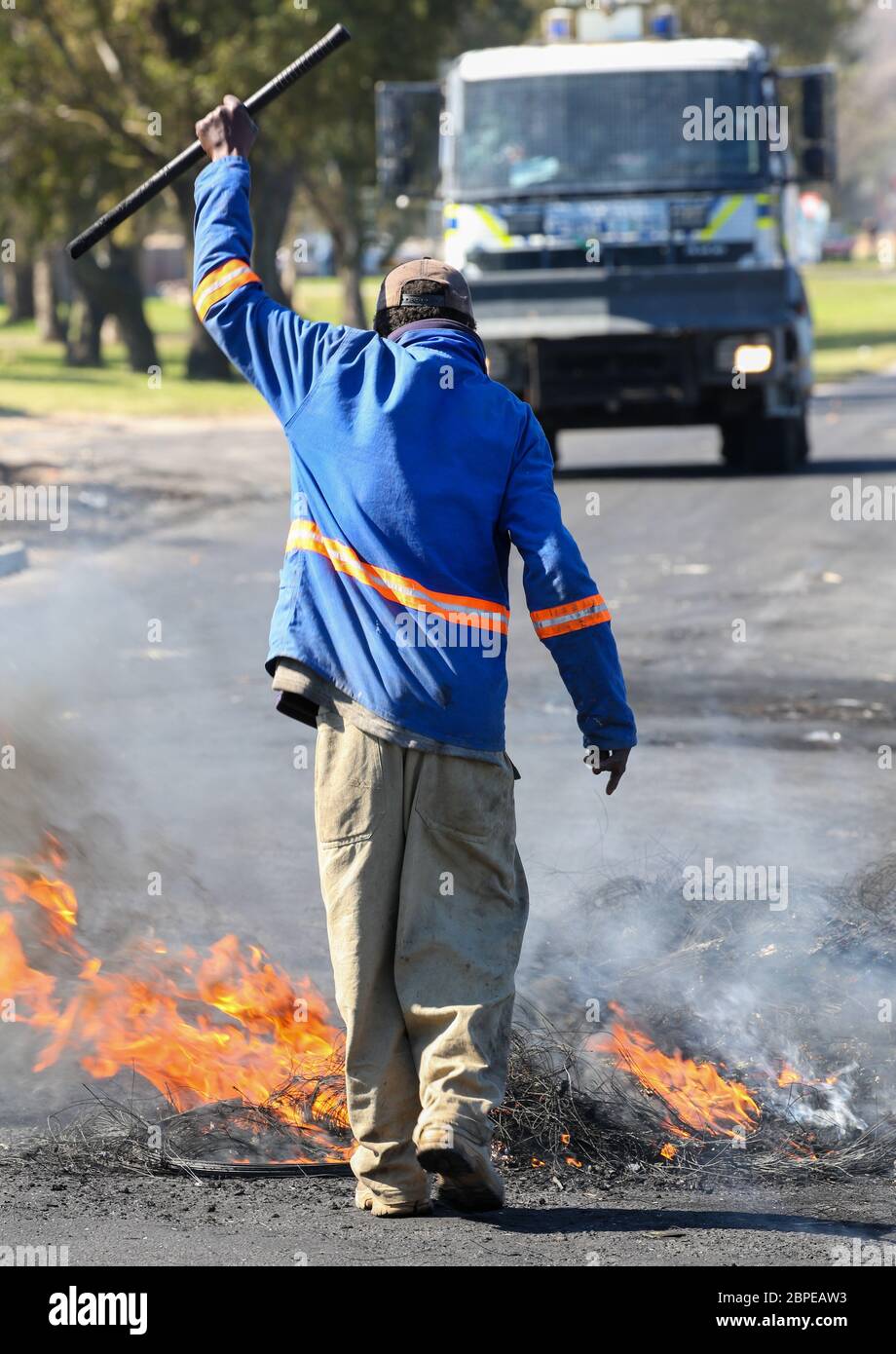 Protester burning rubber tyres in the streets in South Africa with ...