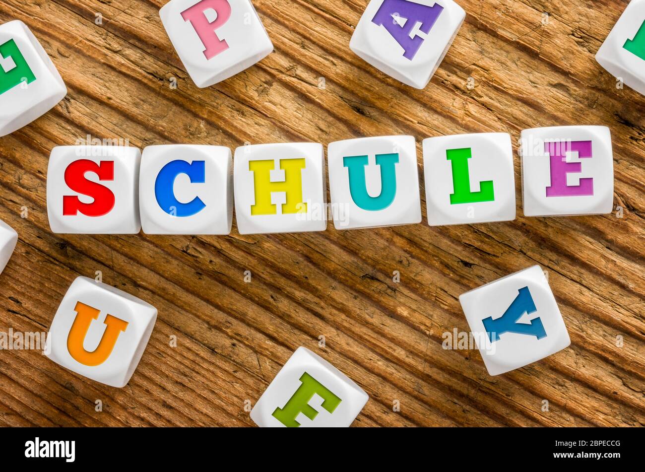 Buchstabenwürfel auf Holzhintergrund - Schule Stock Photo