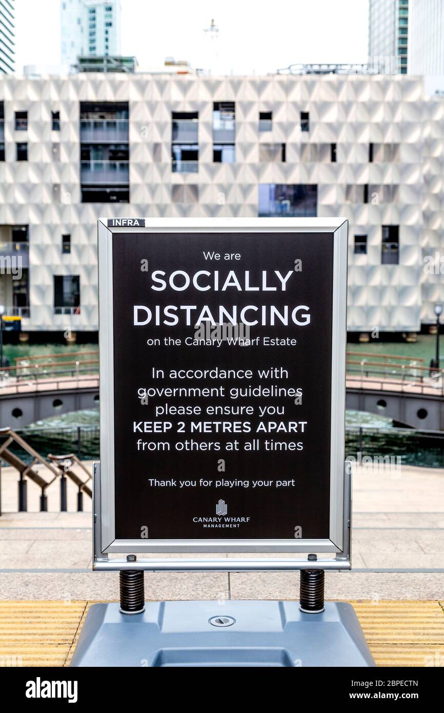 10 May 2020, London, UK - Sign in Canary Wharf asking people to follow government guidelines and keep 2 meters apart during Coronavirus pandemic Stock Photo
