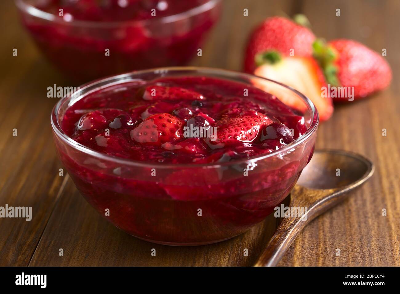 German Rote Gruetze (red groats) red berry pudding made of strawberry, blueberry, raspberry and redcurrants cooked with sugar and starch, photographed Stock Photo