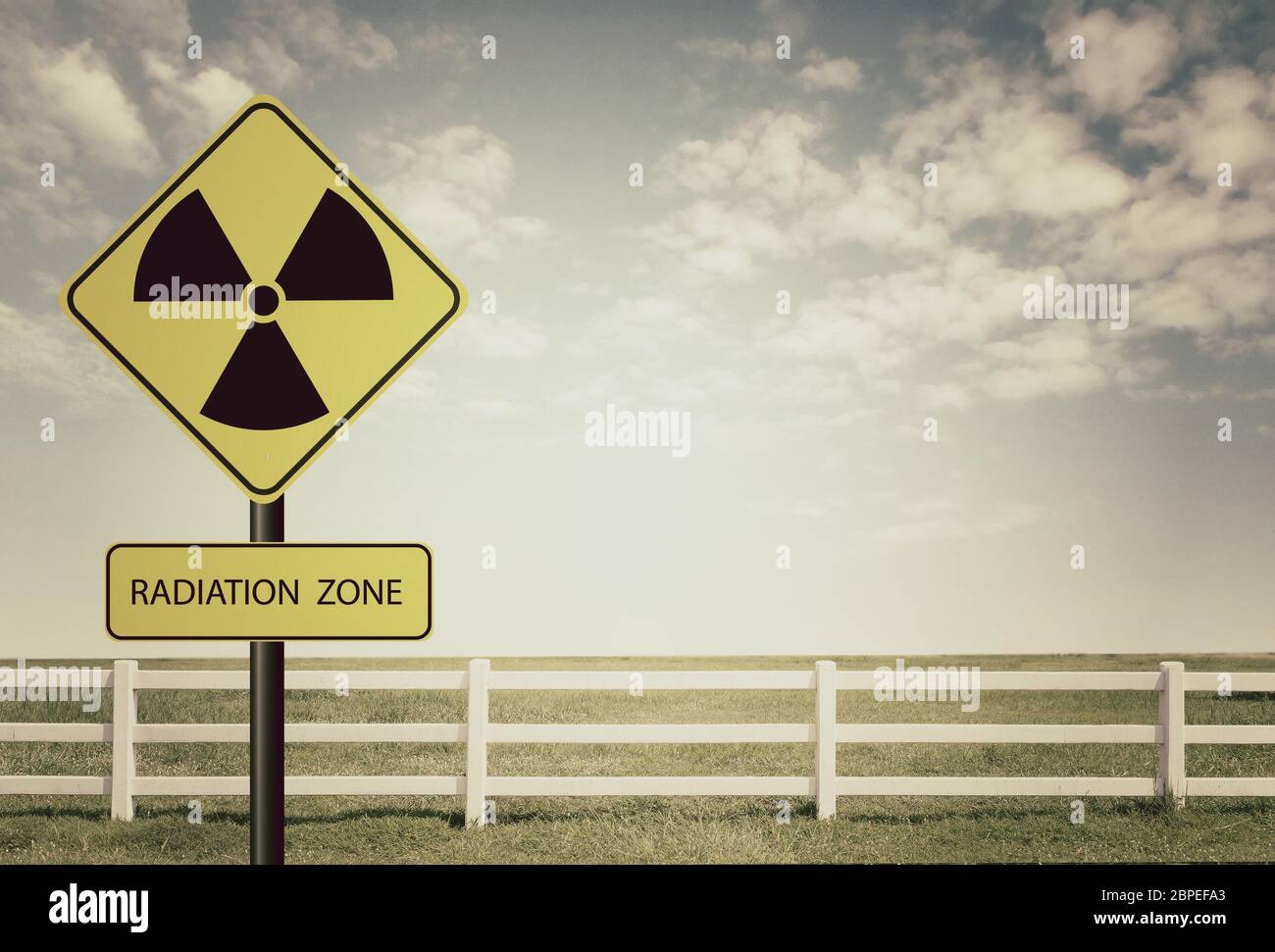 nuclear radiation warning symbol with blue sky Stock Photo