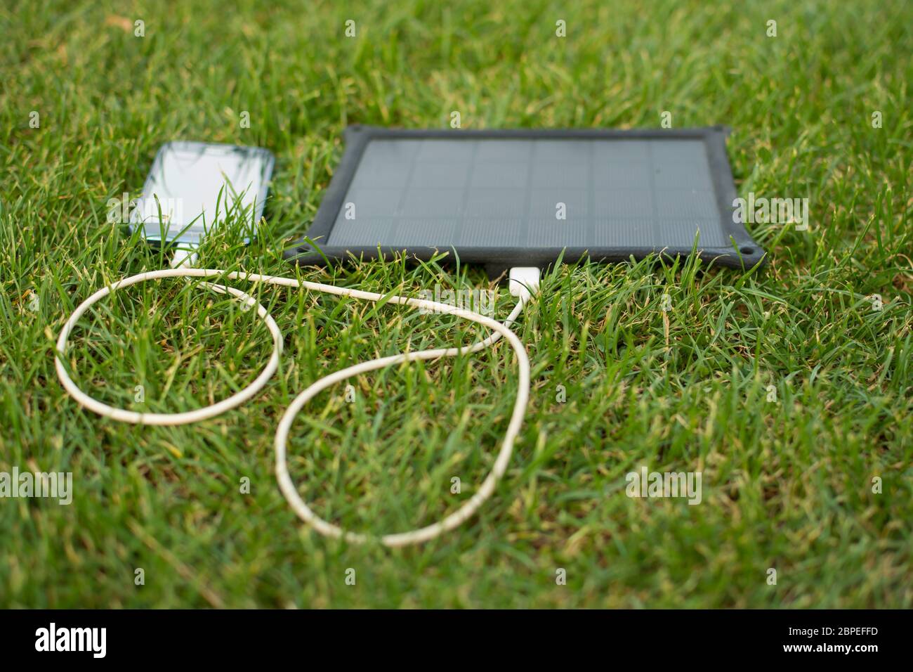 Use of renewable energy Mobile Phone Chargers on grass in nature with