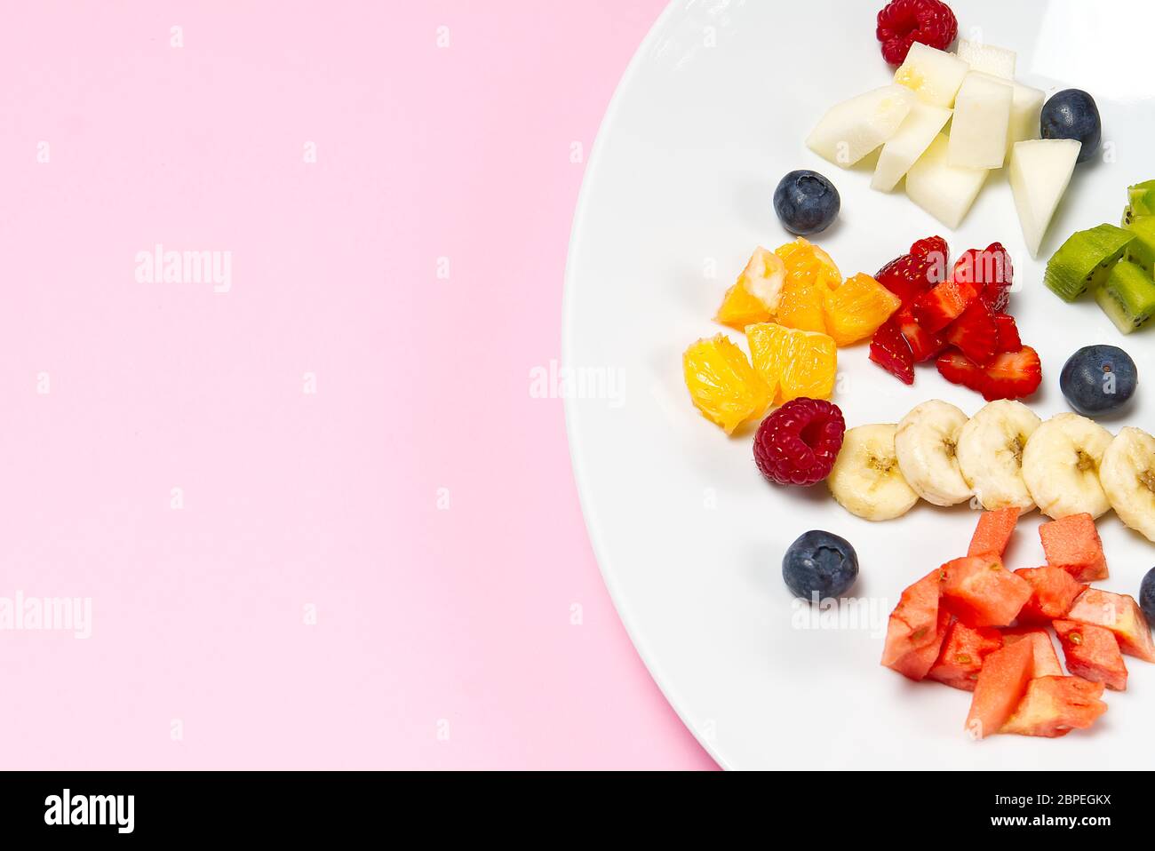 Fresh Fruit Salad On White Plate Mixed Fruit In White Plate Healthy Food Style Useful Fruit Salad Of Fresh Fruits And Berries On Pink Background Stock Photo Alamy