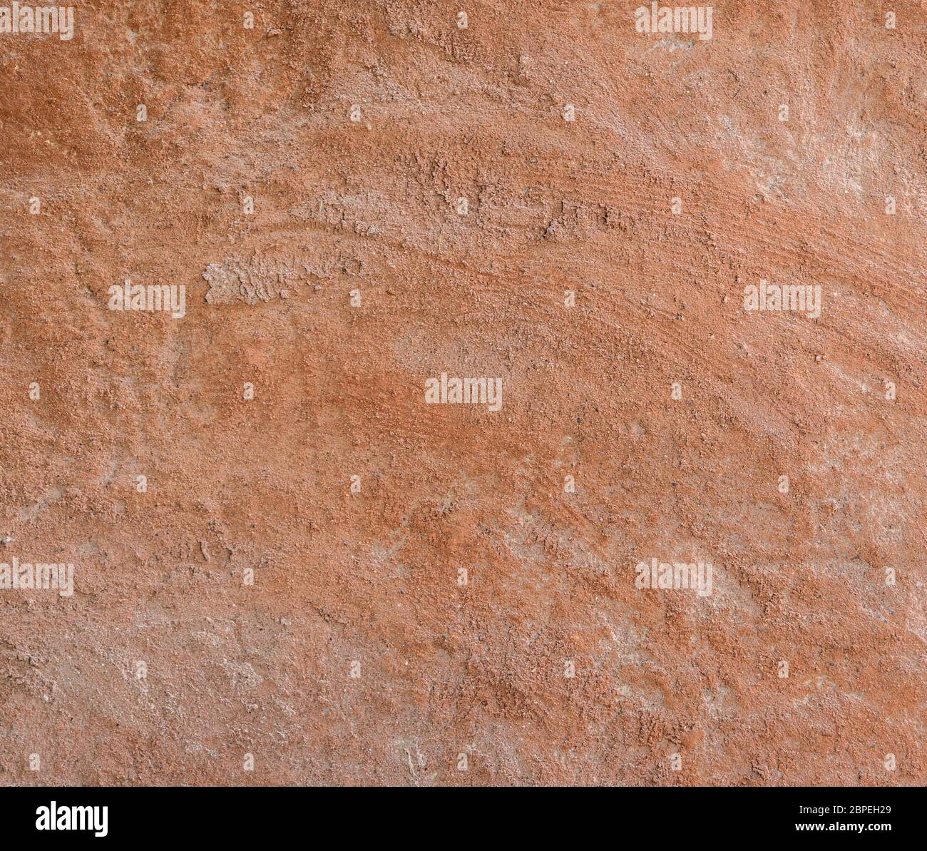 Red natural wall texture of cob house for background. It is a 