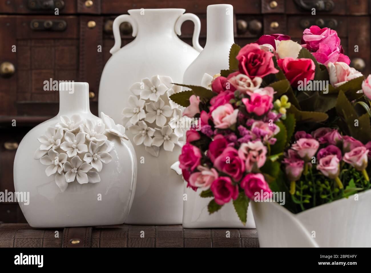 Different decorative white vases with 3d flower and butterfly designs Stock Photo