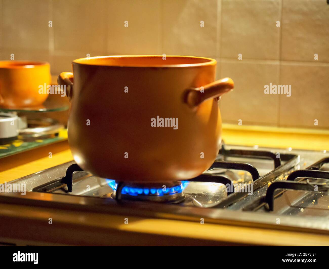 Traditional terracotta pot on the fire, horizontal image Stock Photo