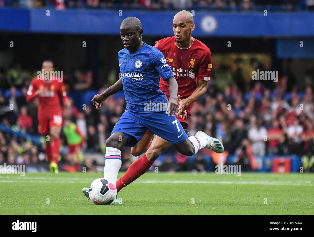 LONDON, ENGLAND - SEPTEMBER 22, 2019: N'Golo Kante of Chelsea (front) and Fabio Henrique Tavares (Fabinho) of Liverpool (back) pictured during the 2019/20 Premier League game between Chelsea FC and Liverpool FC at Stamford Bridge. Stock Photo