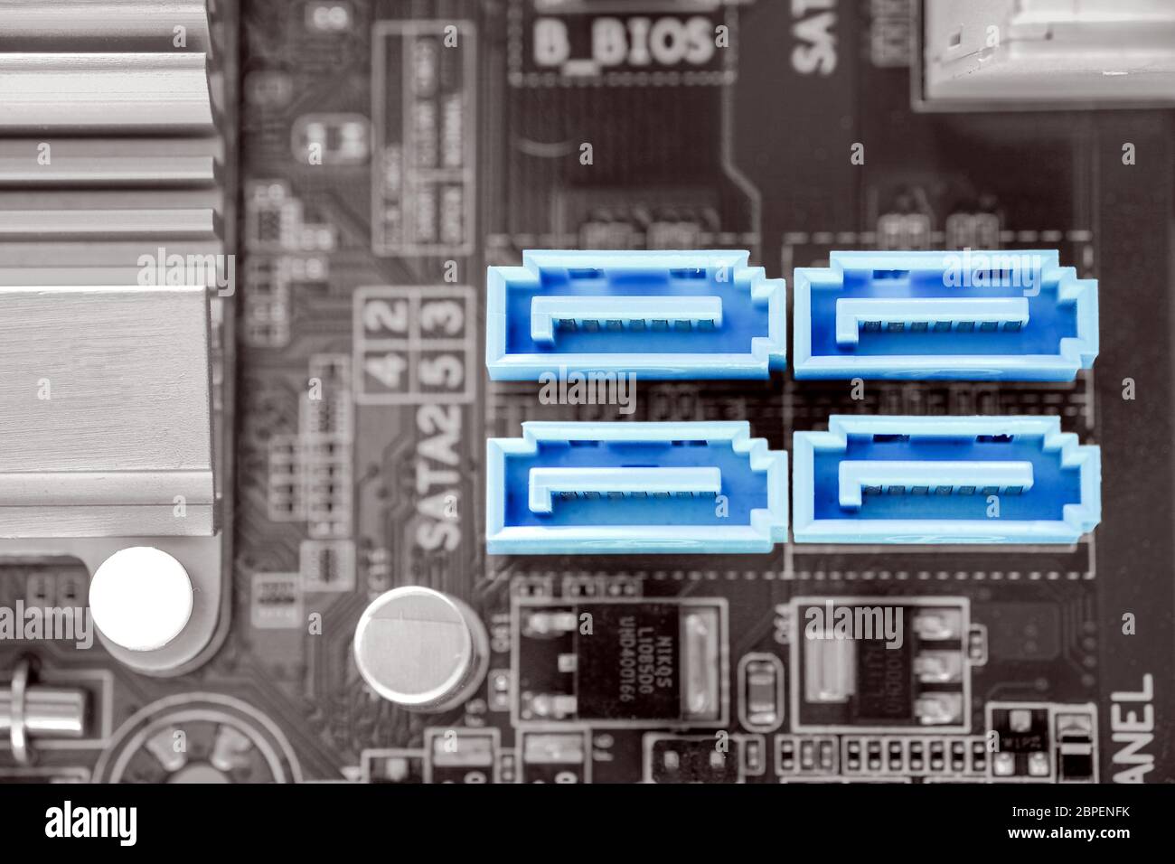 Blue color 4x SATA-II port in desktop PC motherboard on black and white color filter, SATA-II is a port for hard disk connectivity Stock Photo