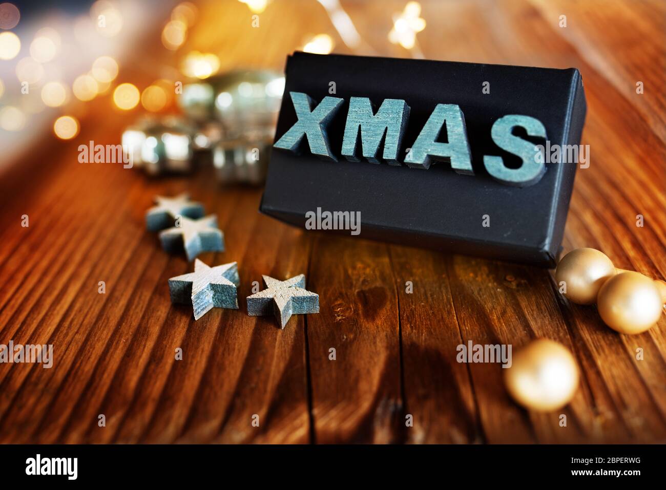 Christmas decoration with stars and a surprise gift on a rustic wooden table Stock Photo