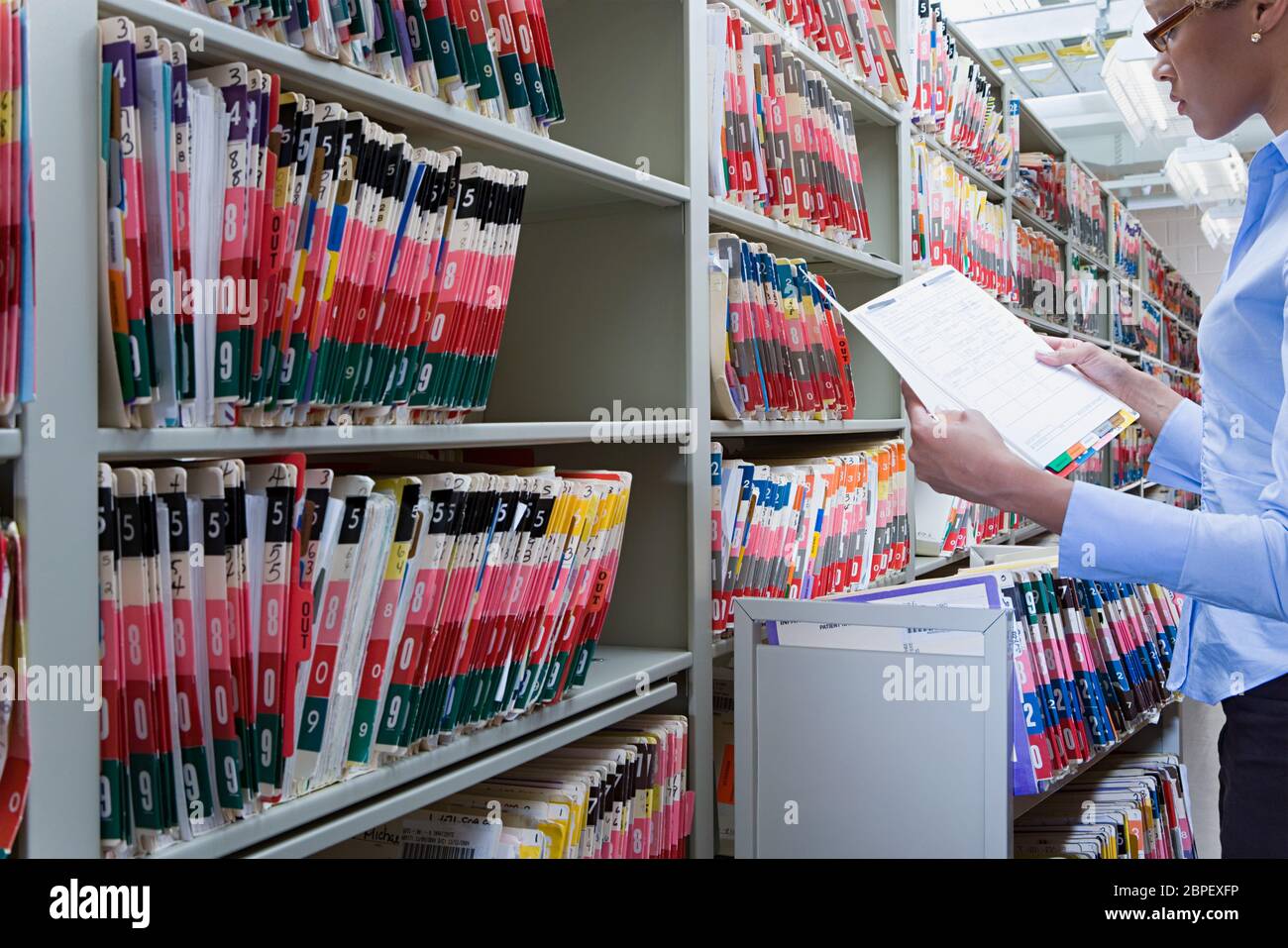 A stack of patient medical records in folders with color-coded and numbered  tabs Stock Photo - Alamy