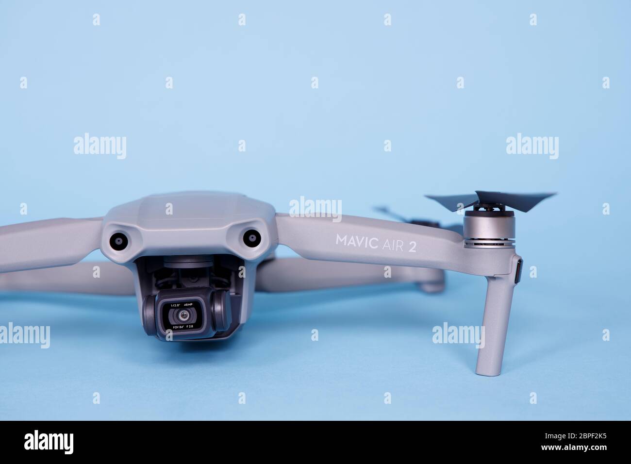 Closeup view of Dji Mavic Air 2 model 2020 drone on blue background Quadcopter with 4k HDR Video HDR and 48MP photo camera. Stock Photo