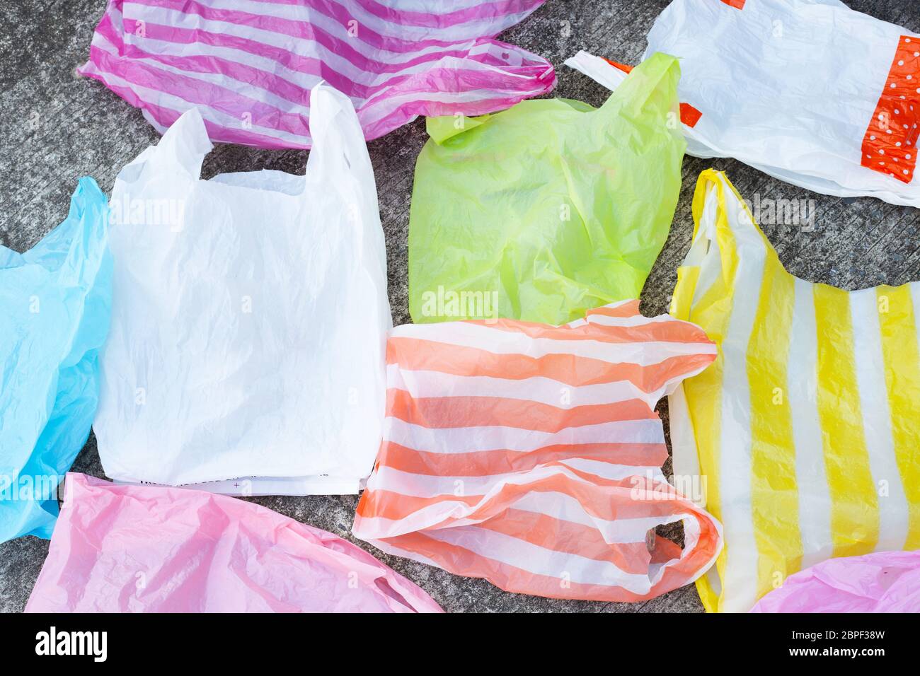 Plastic bags on cement floor background. Stock Photo
