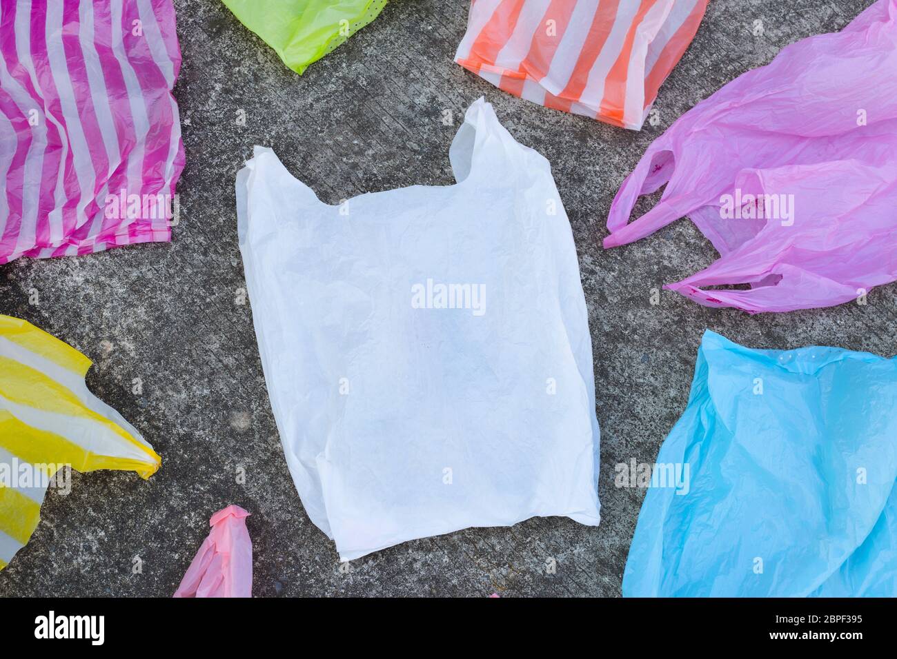 Plastic bags on cement floor background. Stock Photo