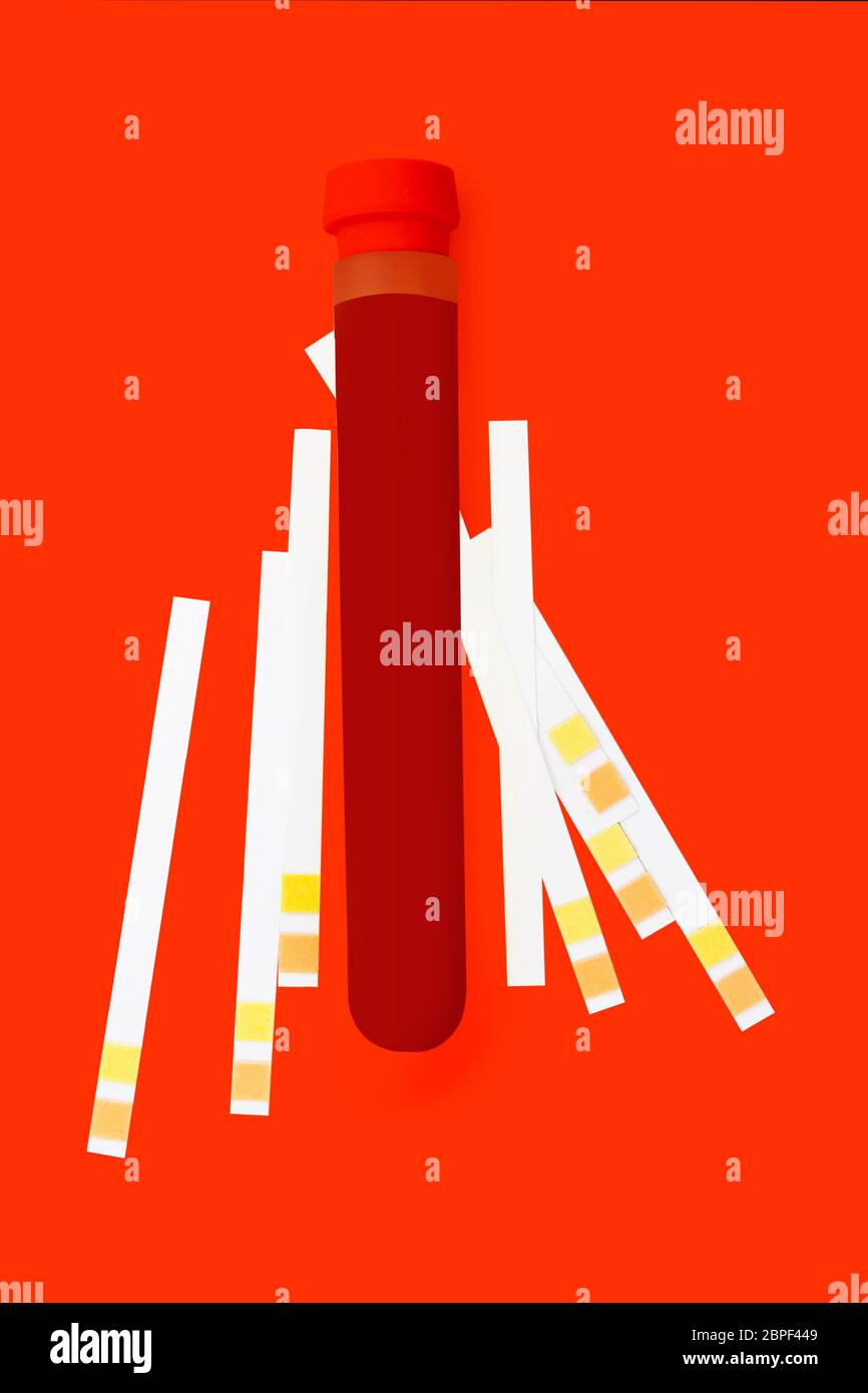 Biohacking backgound. Blood in test tube and ph test strips flat lay