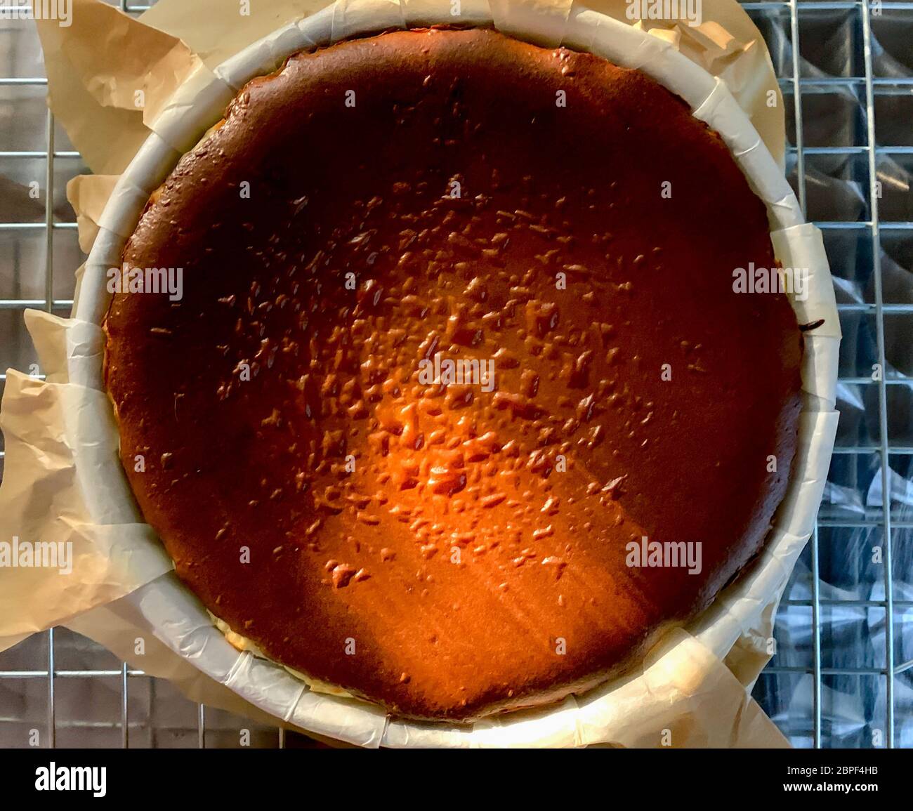 Top view of texture Basque burnt cheesecake on a tray with baking paper