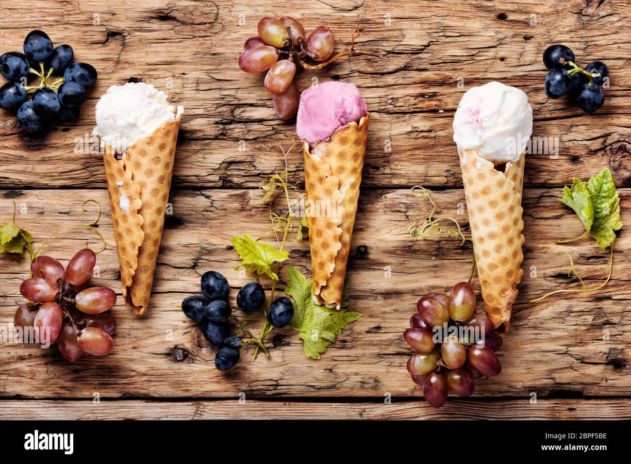 Ice cream sundae, waffle cone.Grape ice cream.Ice cream cones on wooden