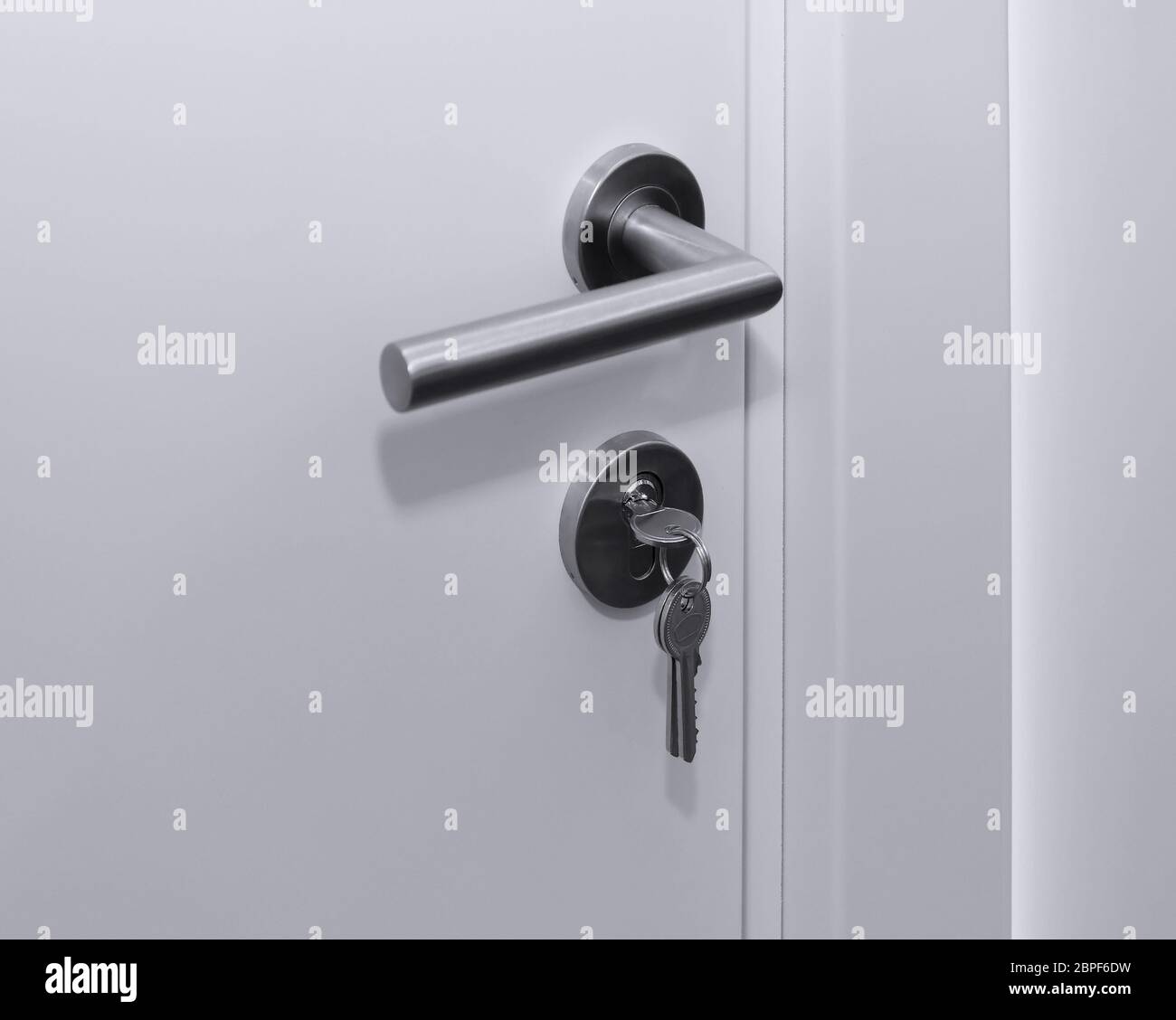 Silver key inside door lock from outside Stock Photo Alamy