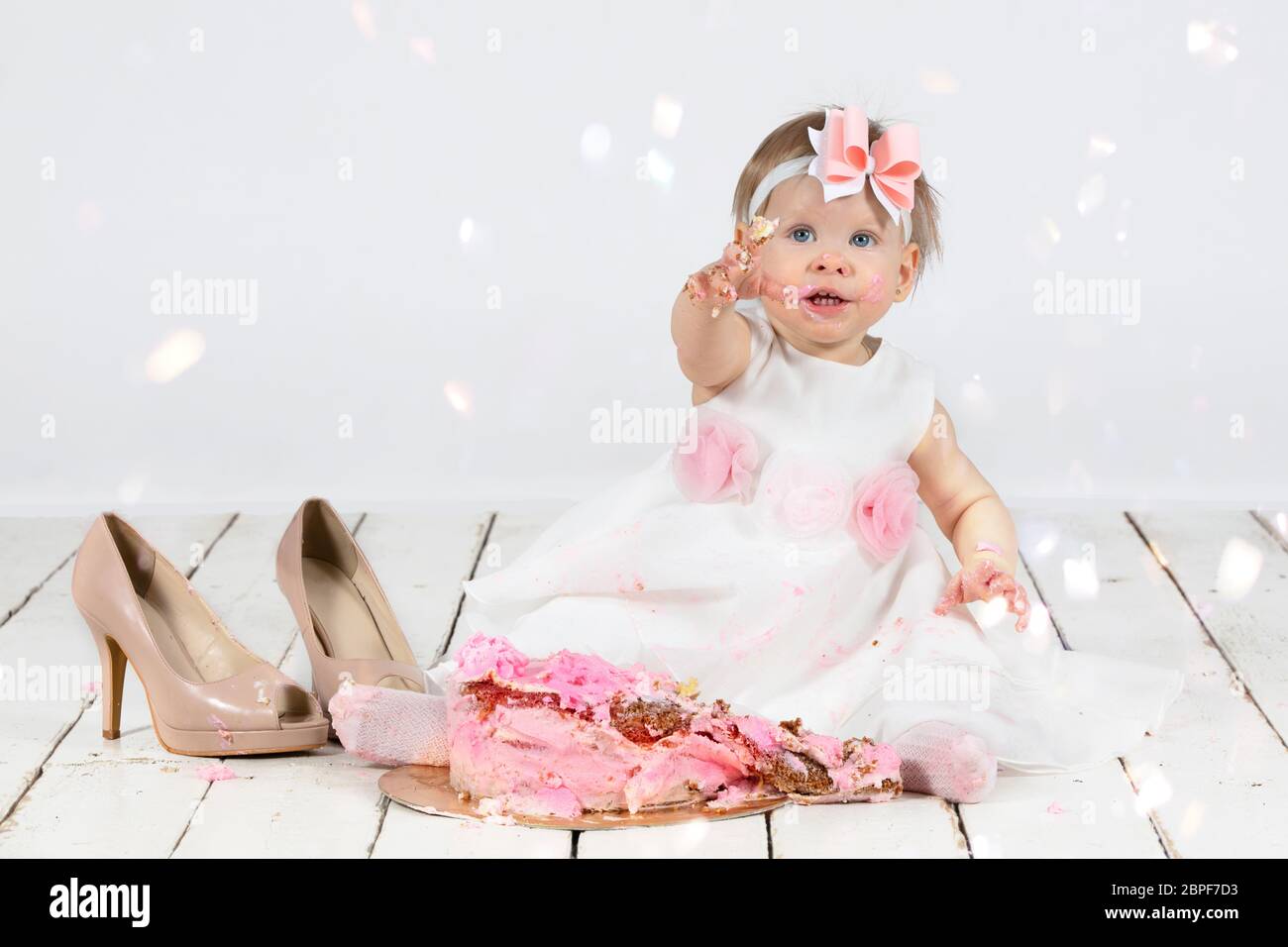 One year old child with a birthday cake. Funny little girl smeared with  cream on the first anniversary. Funny child on holiday Stock Photo - Alamy