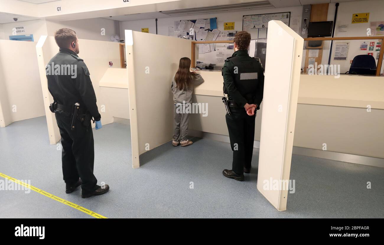 An adult female detained person is booked in by a custody Sergeant at Musgrave Custody Suite in Belfast. PA Media was given exclusive first access to the Covid-19 block to witness how the Police Service of Northern Ireland (PSNI) has adapted to the challenges of custody in a pandemic. Stock Photo