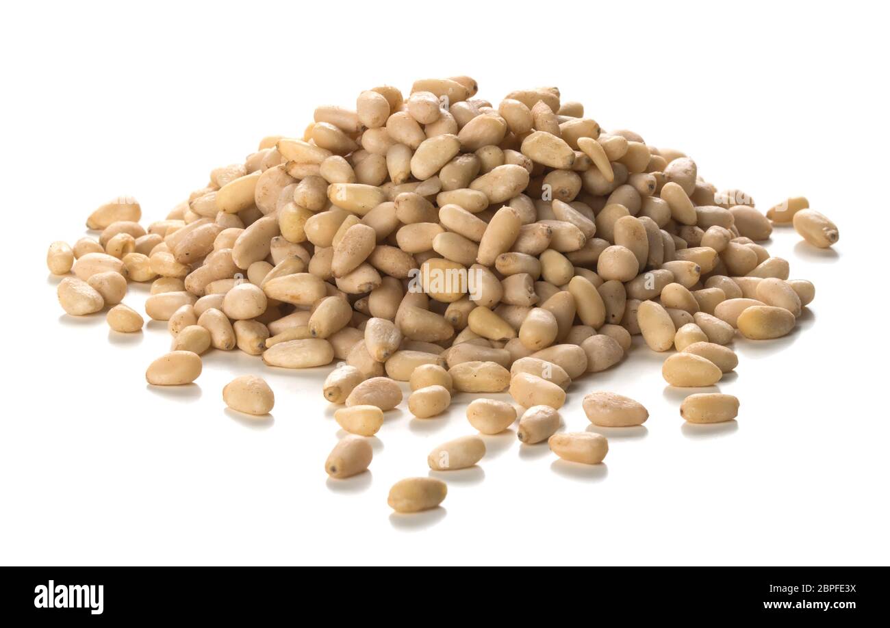 Close up photography of pine nuts heap over white background. Packshot style Stock Photo