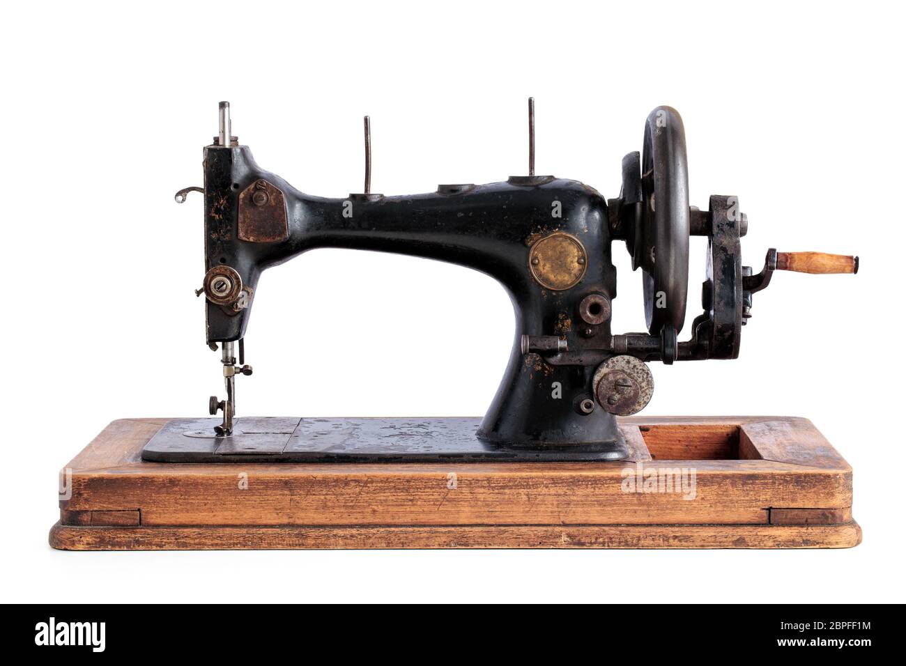 Ancient sewing machine isolated on white background Stock Photo - Alamy