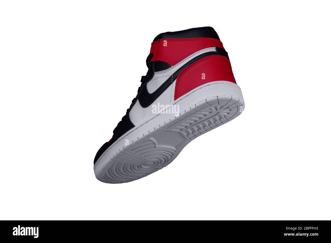 A high sneaker with red and black accents. Athletic boot Stock Photo ...