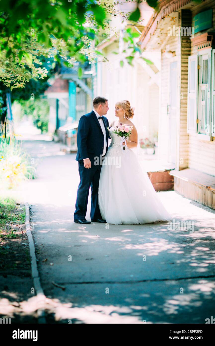 bride and groom on the background of the city Stock Photo - Alamy
