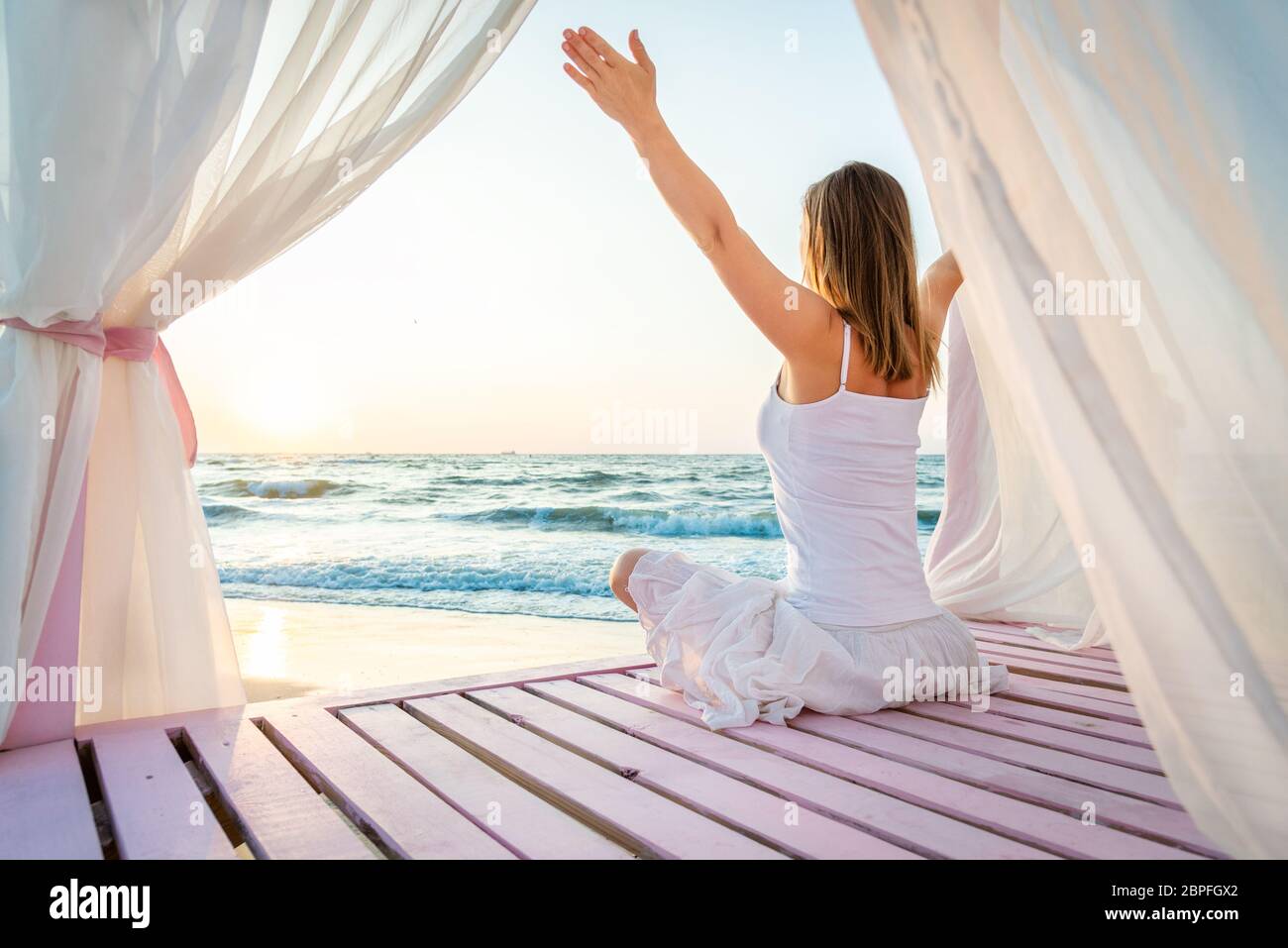 Woman meditating at the sea Stock Photo - Alamy