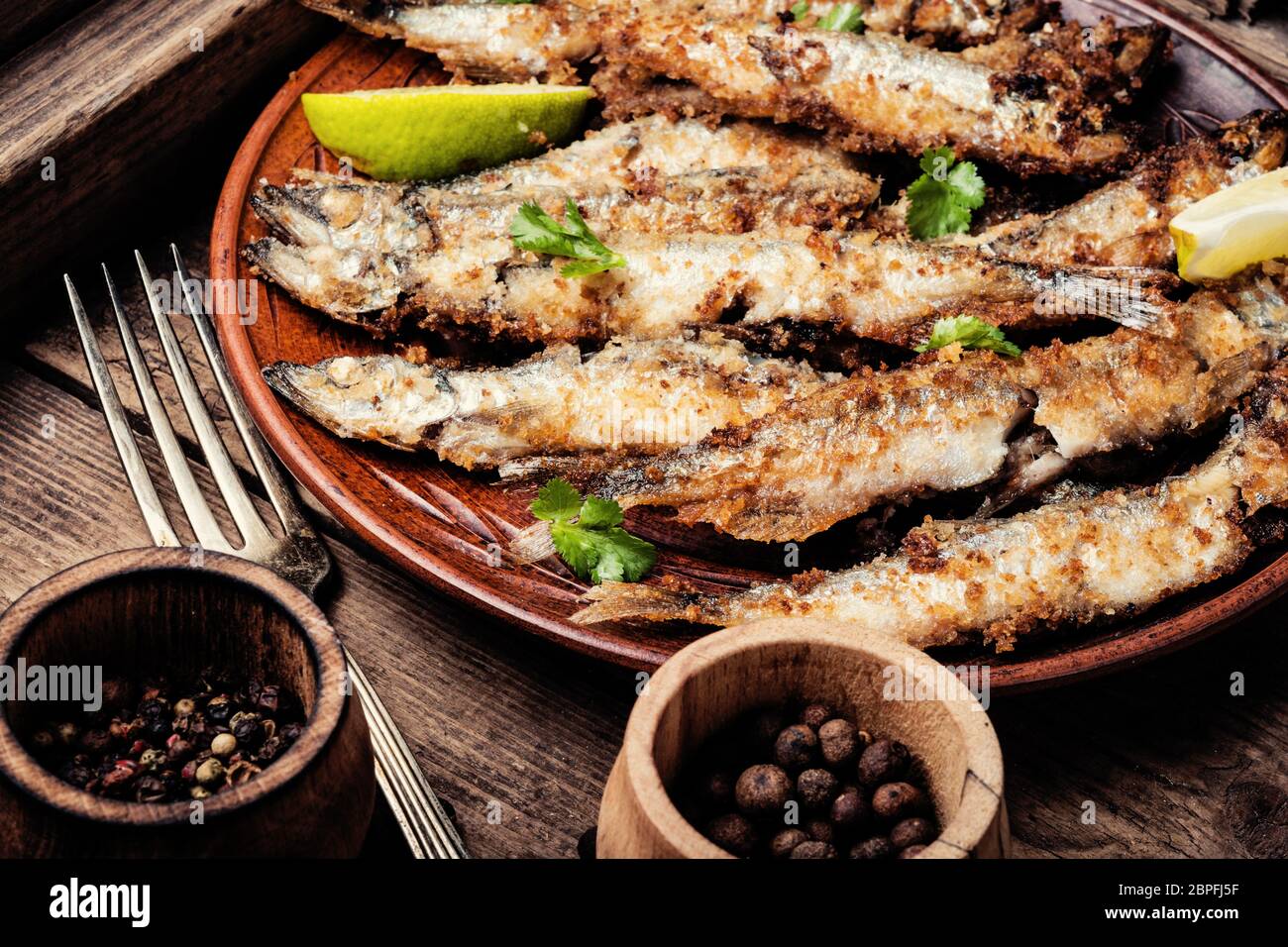 Crispy deep fried small fish on plate Stock Photo Alamy