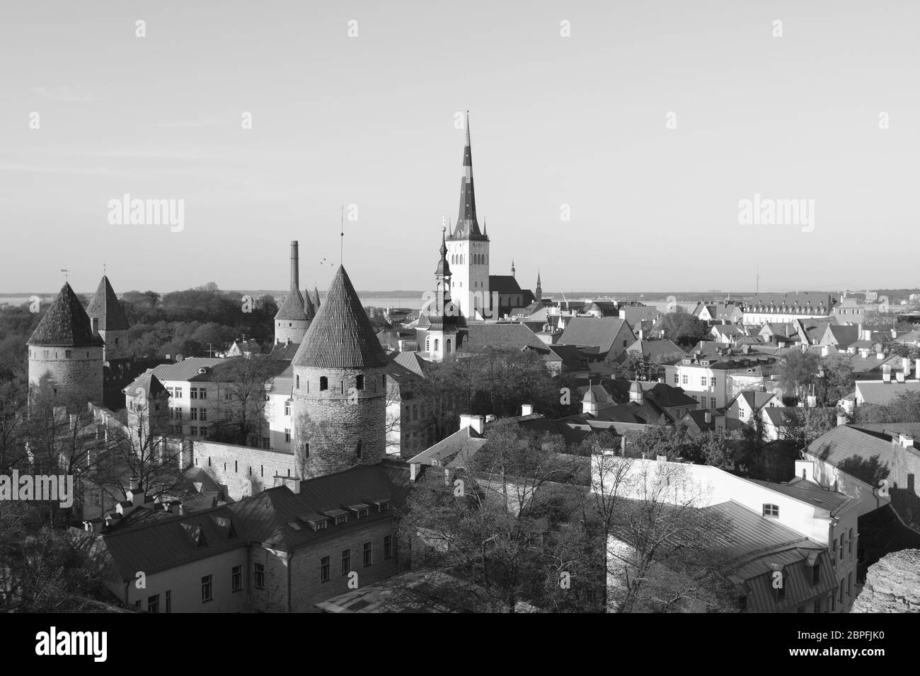 Cityscape of Tallinn, Estonia - a UNESCO World Heritage site - fortifications in the medieval city wall and church towers rise above the houses - mono Stock Photo