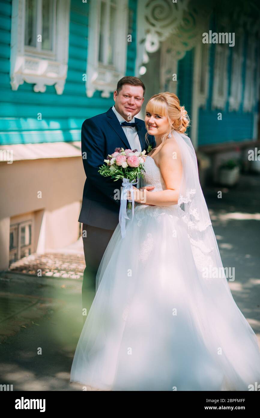 bride and groom on the background of the city Stock Photo - Alamy
