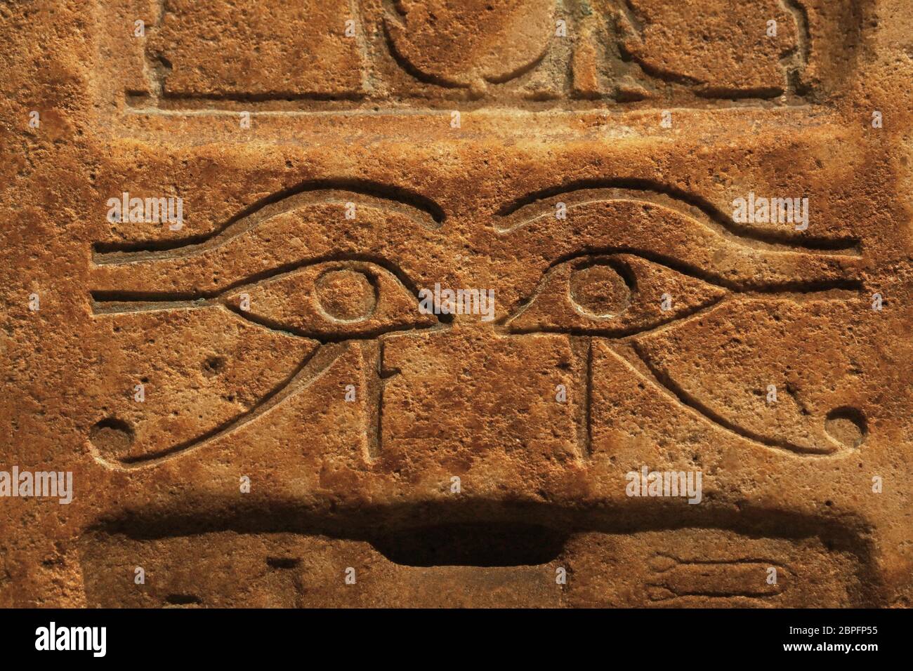 Close up background of antique stone wall with carved ancient Egyptian bas  relief of wadjet, Eye of Ra or Horus, front view Stock Photo - Alamy