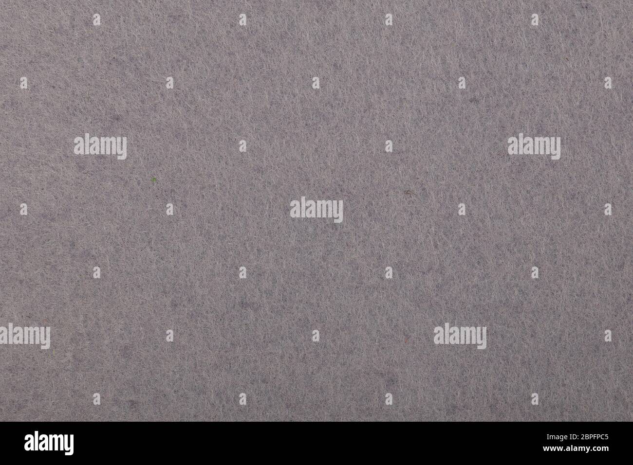Neutral light grey felt textile material background texture close up