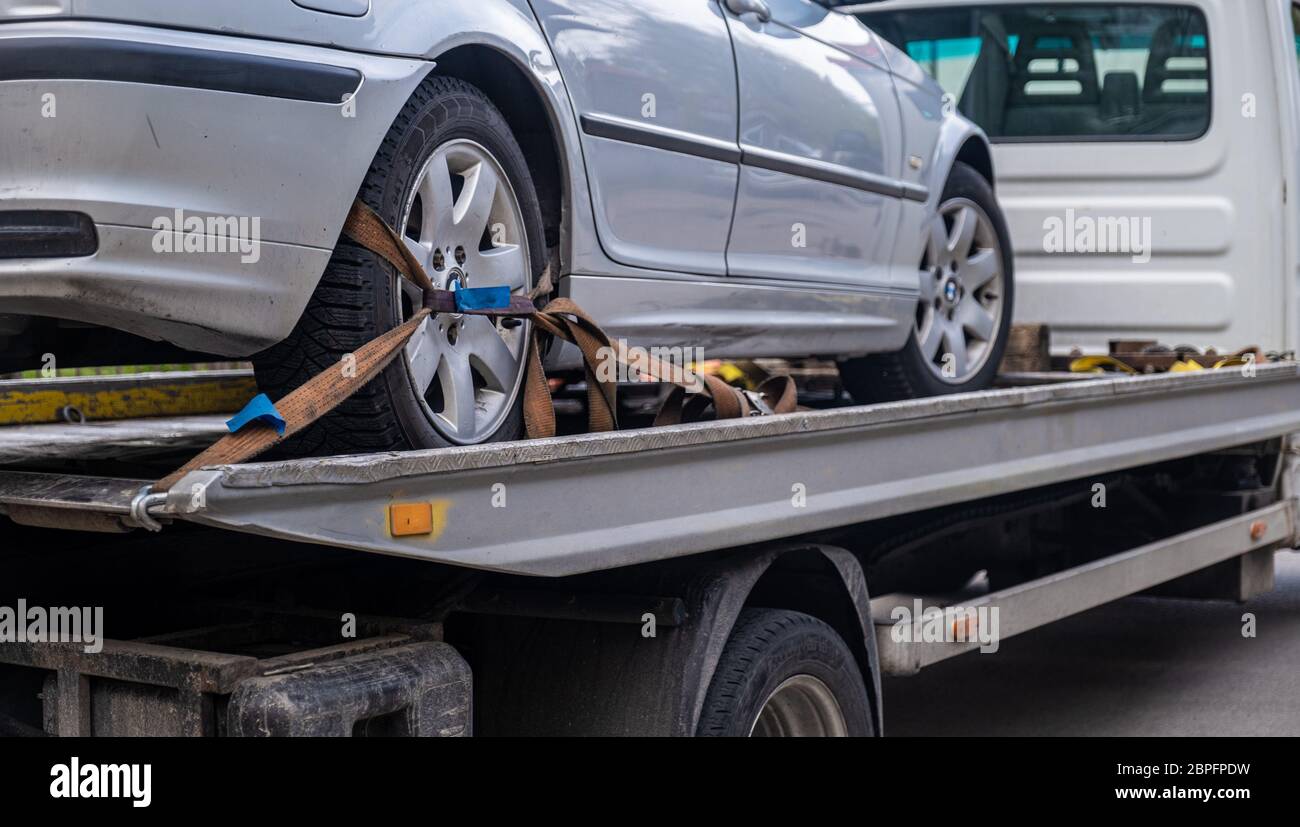 Loaded broken car on a tow truck. Car being towed. Damage vehicle after