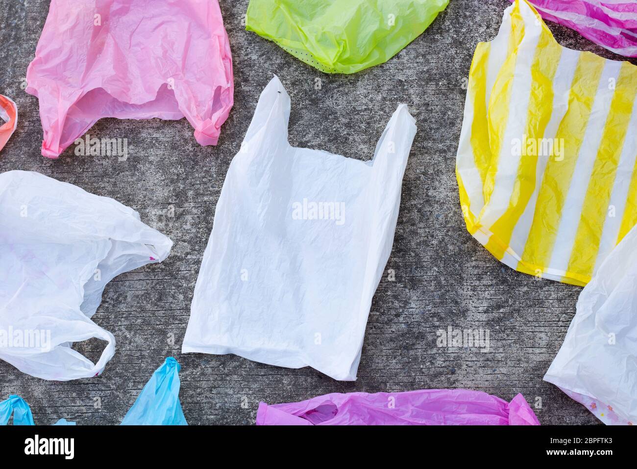 Plastic bags on cement floor background. Stock Photo