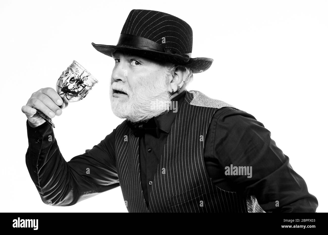 On Halloween night. evil wizard cooking magic potion with spider. mature man magician in witch hat. happy halloween. barman make cocktail for halloween party. halloween holiday costume. Stock Photo