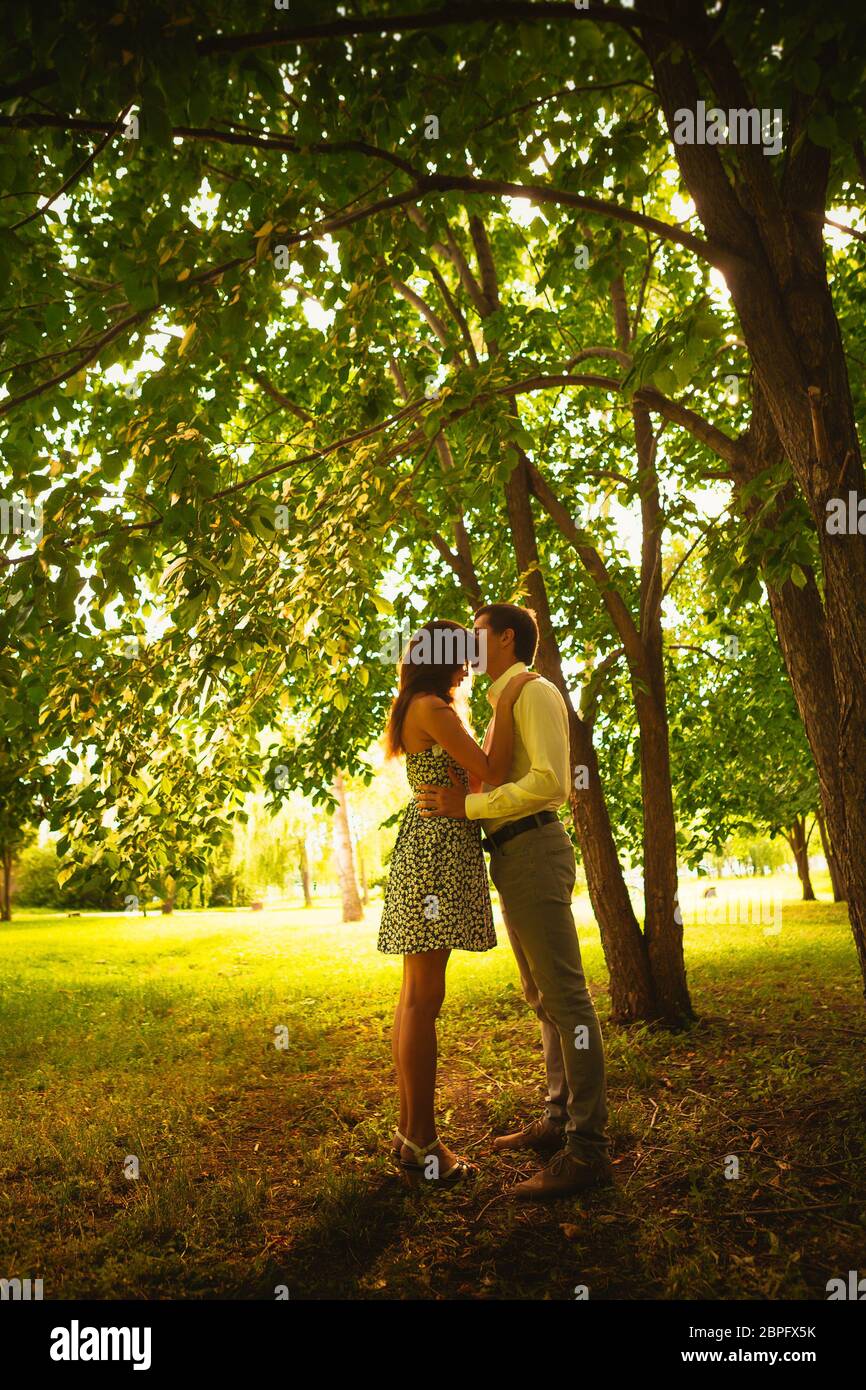 Beautiful young couple in the park Stock Photo - Alamy