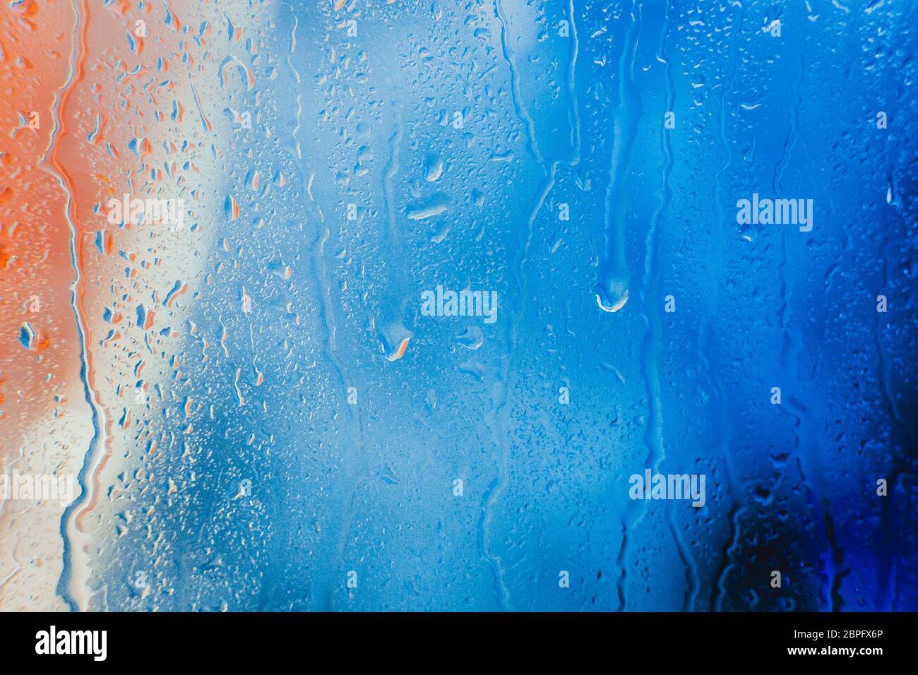 Drops on the glass rain blue background Stock Photo - Alamy