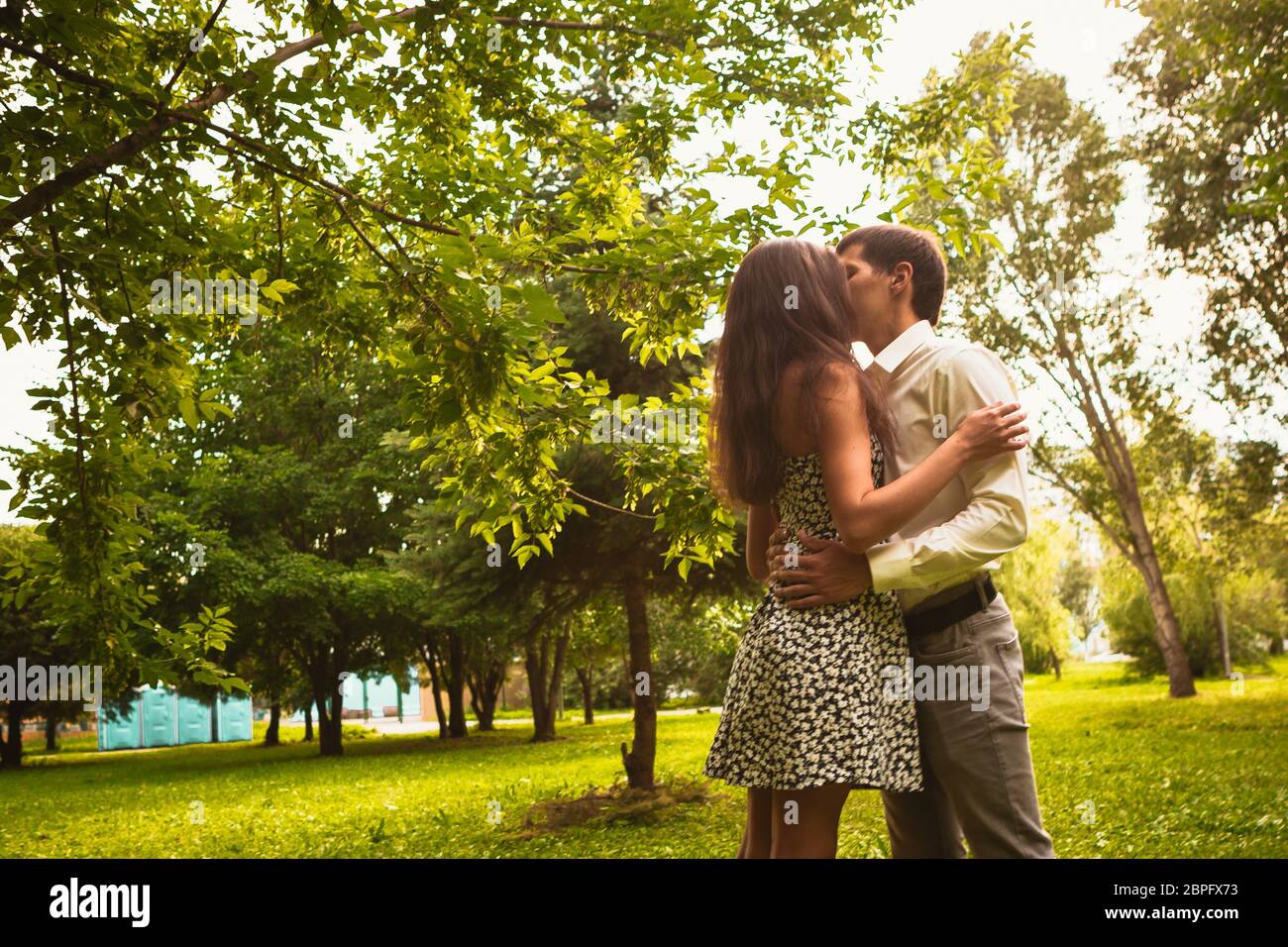 Beautiful young couple in the park Stock Photo - Alamy