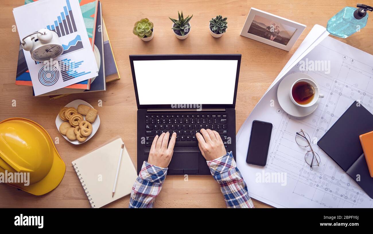 work from home. designer, engineer typing on computer keyboard working via laptop with blank screen for copy space during home isolation Stock Photo