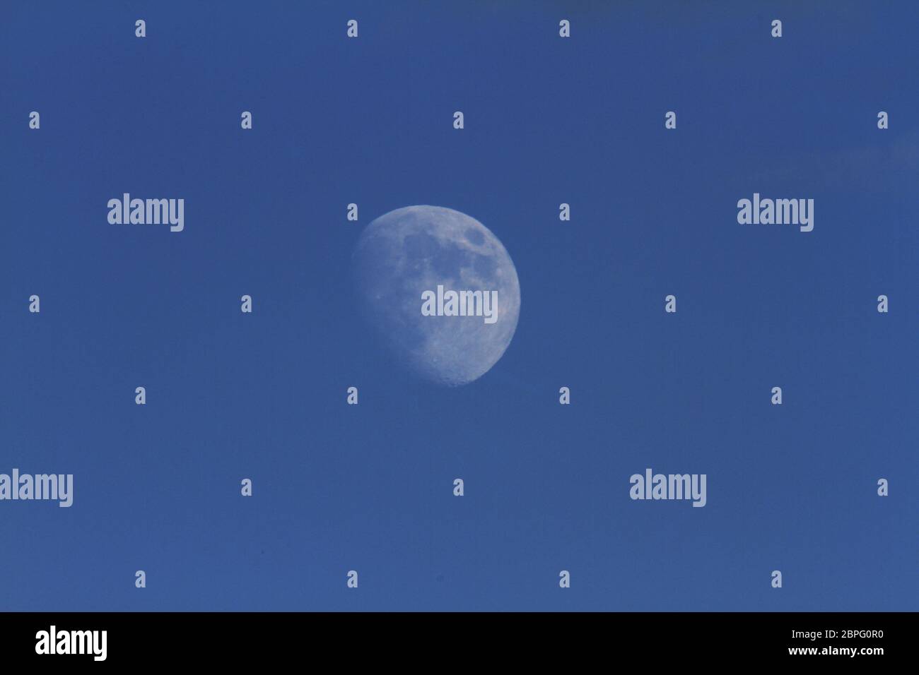 zoom moon in blue sky Stock Photo