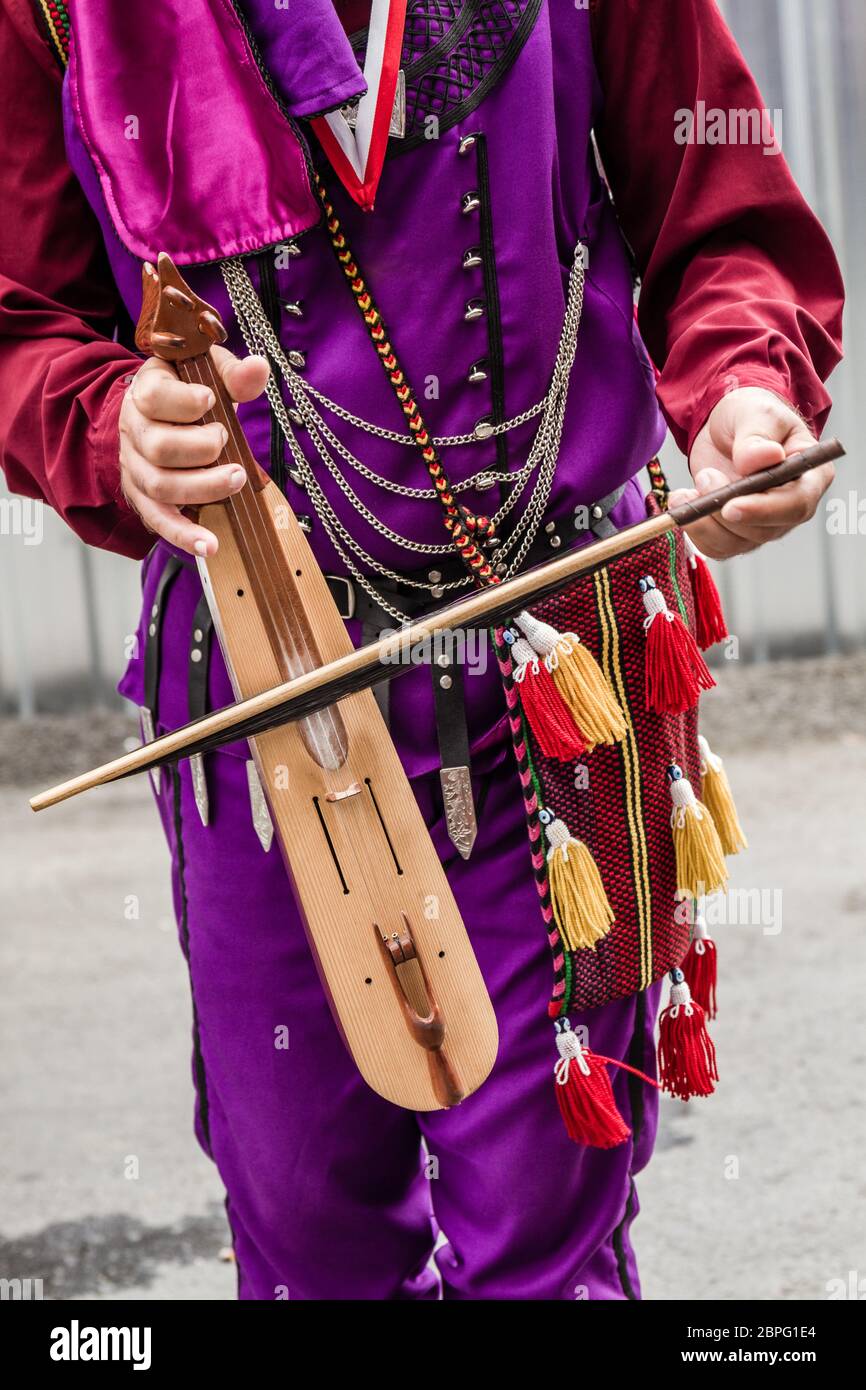 Musician with local clothing playing authentic Turkish fiddle, kemence Stock Photo