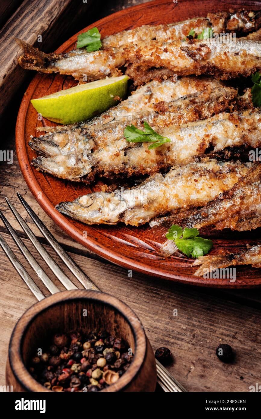 Crispy deep fried small fish on plate Stock Photo Alamy