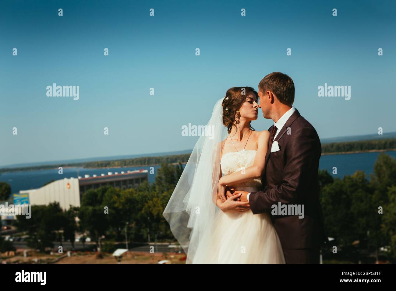 young bride and groom couple on the sky background Stock Photo - Alamy