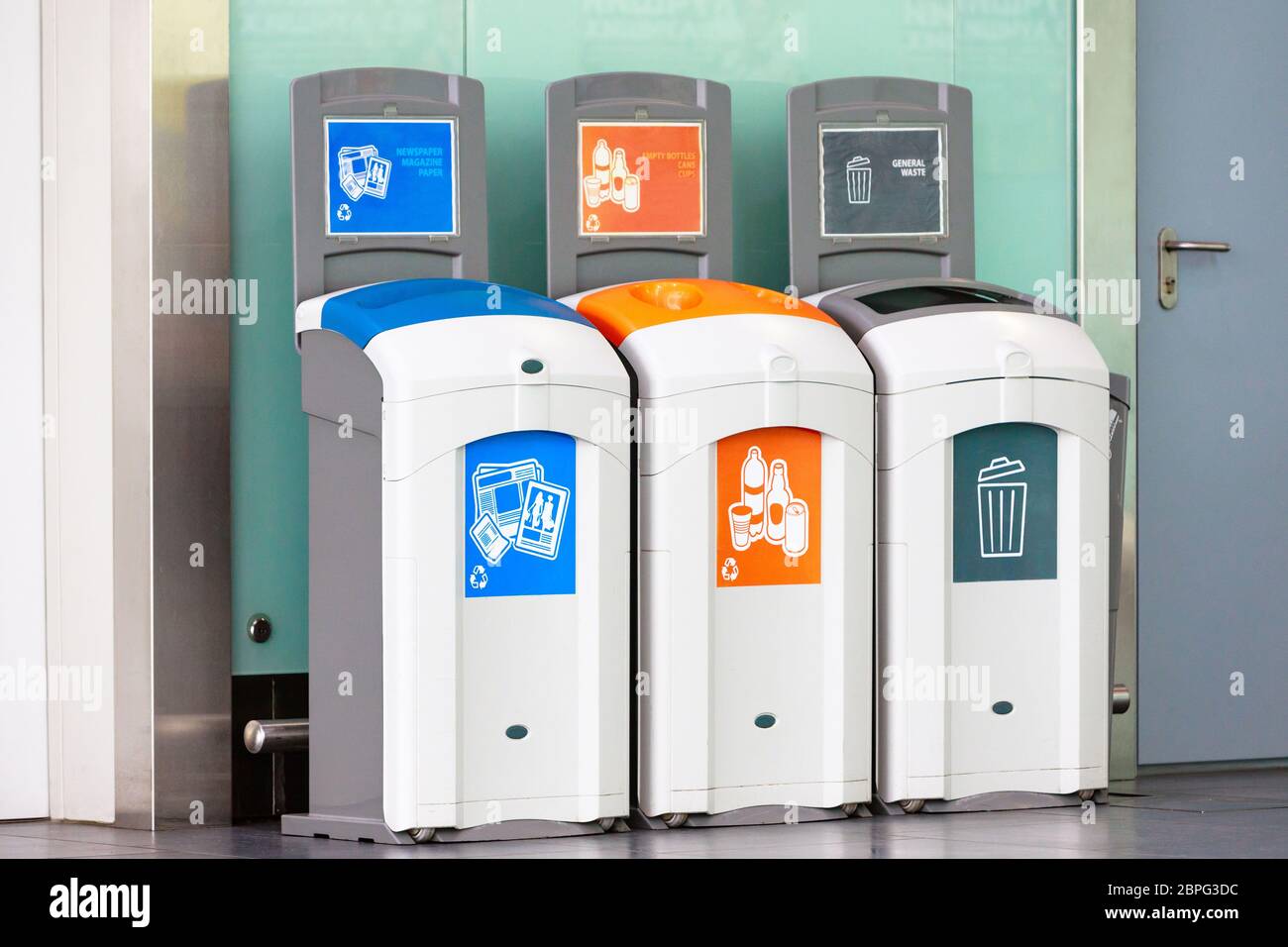 Rubbish bins for different garbage - plastic, empty bottles, newspaper, magazine paper and general waste. Stock Photo