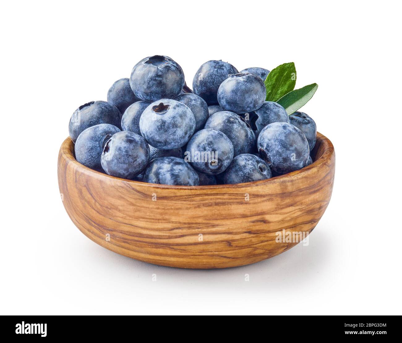 Beautiful blueberries with blueberry leaves in wooden bowl isolated on white background. Stock Photo