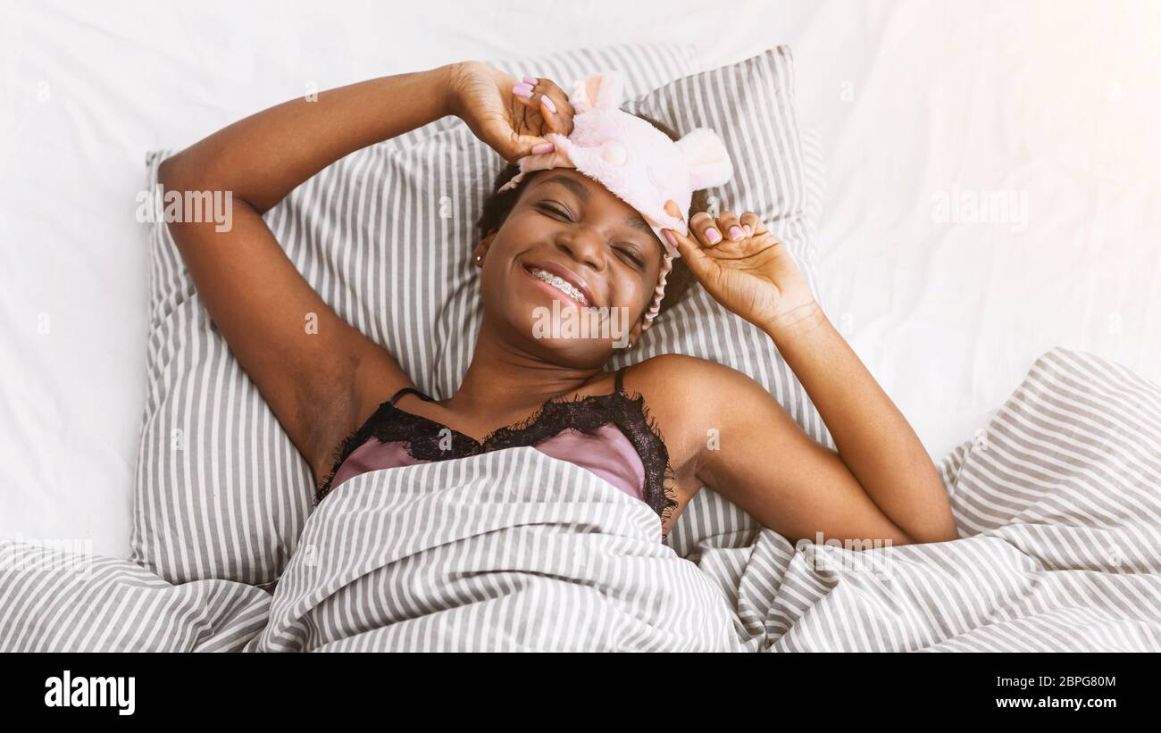 A Young Girl, in a Bra and a Sleeping Mask, Holds a Bottle of Alcohol and  Looks at it. on a Red Background. Stock Photo - Image of excitement,  breast: 106671990